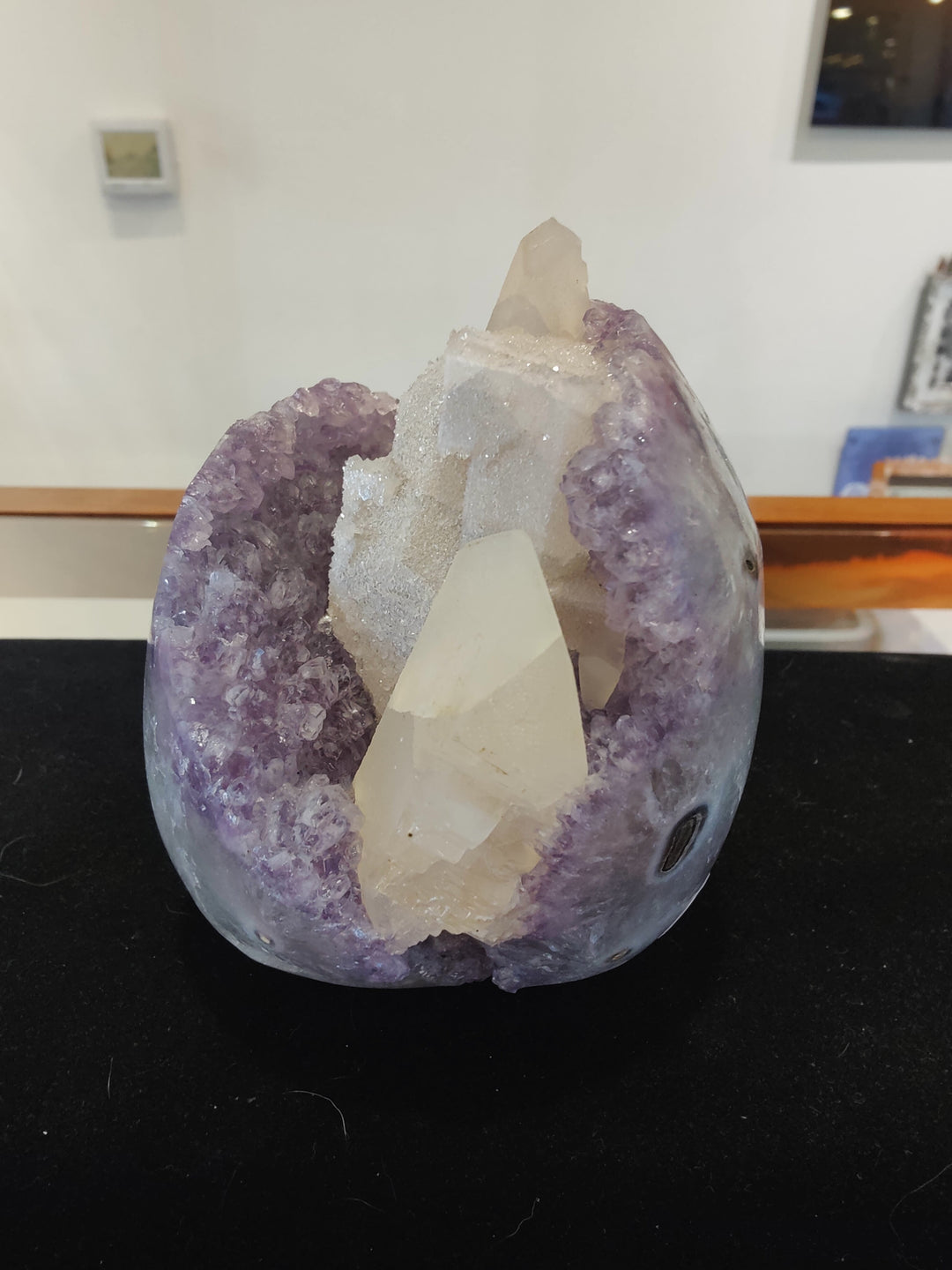 Amethyst geode sculpture with purple crystal shell and white calcite center cluster