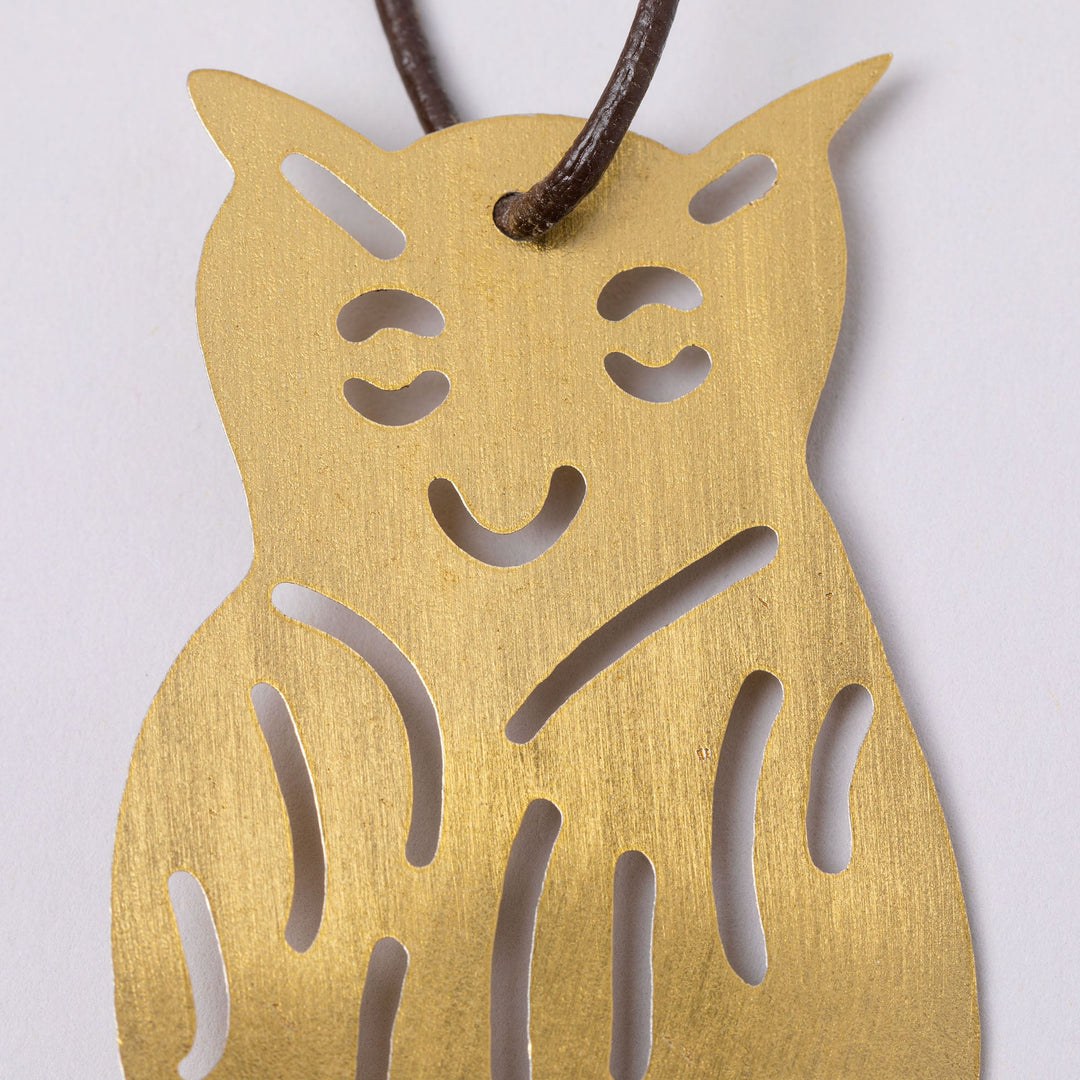 Gold-tone owl iron wind chime medallion with cutout face details