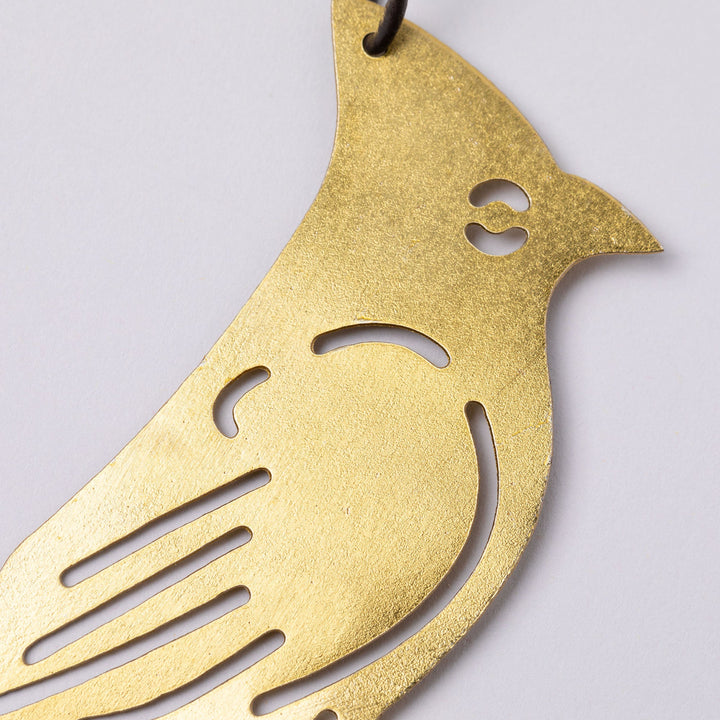 Gold-tone bird iron wind chime silhouette with cutout eye and beak details