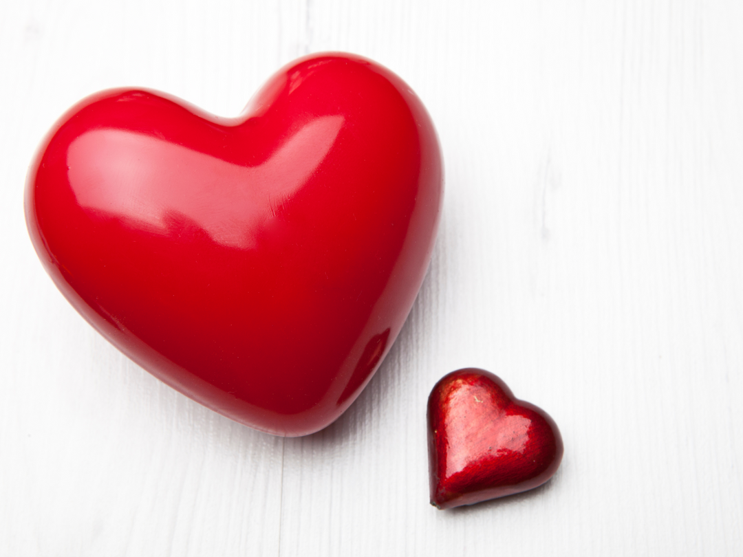 Red heart wax freshener with a smaller red heart beside it on a surface