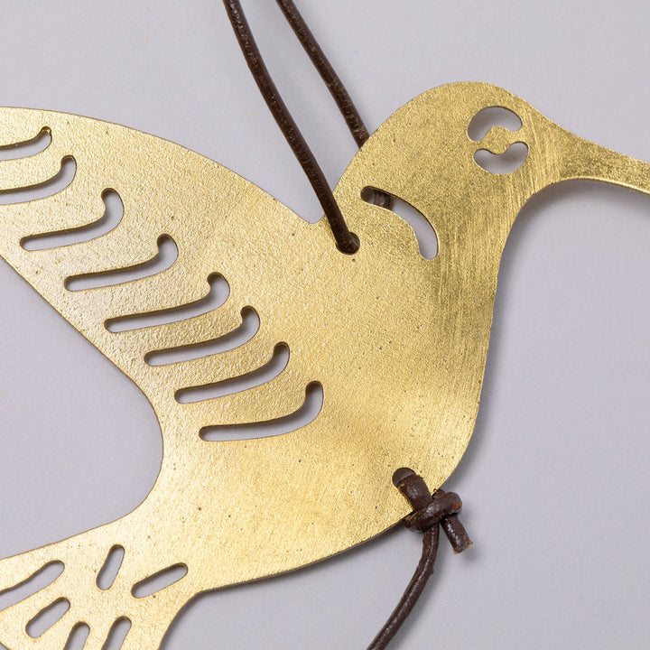 Gold-tone bird iron wind chime silhouette with cutout feather and beak details