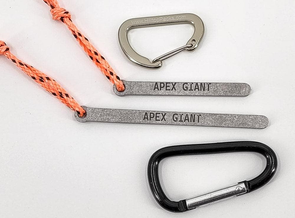 Bear bag toggle with grey bars, orange braided cord, and black carabiner