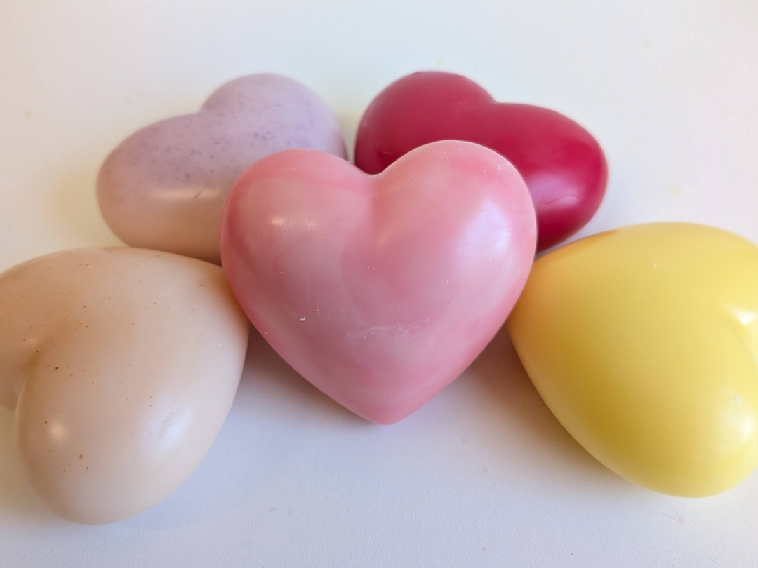 Colorful heart wax fresheners stacked: beige, purple, pink, red, and yellow