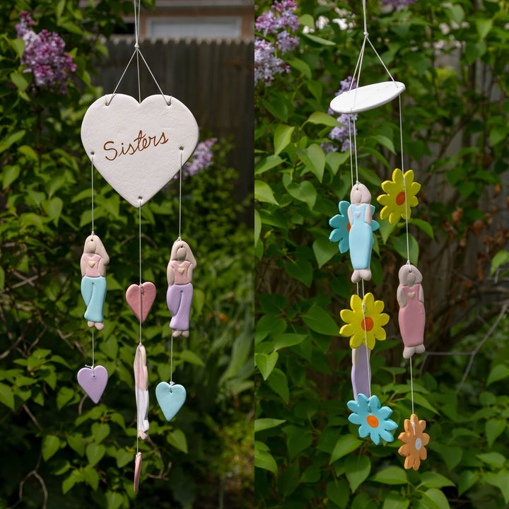 Ceramic chime with heart tag reading Sisters and pastel flower-and-dancer charms