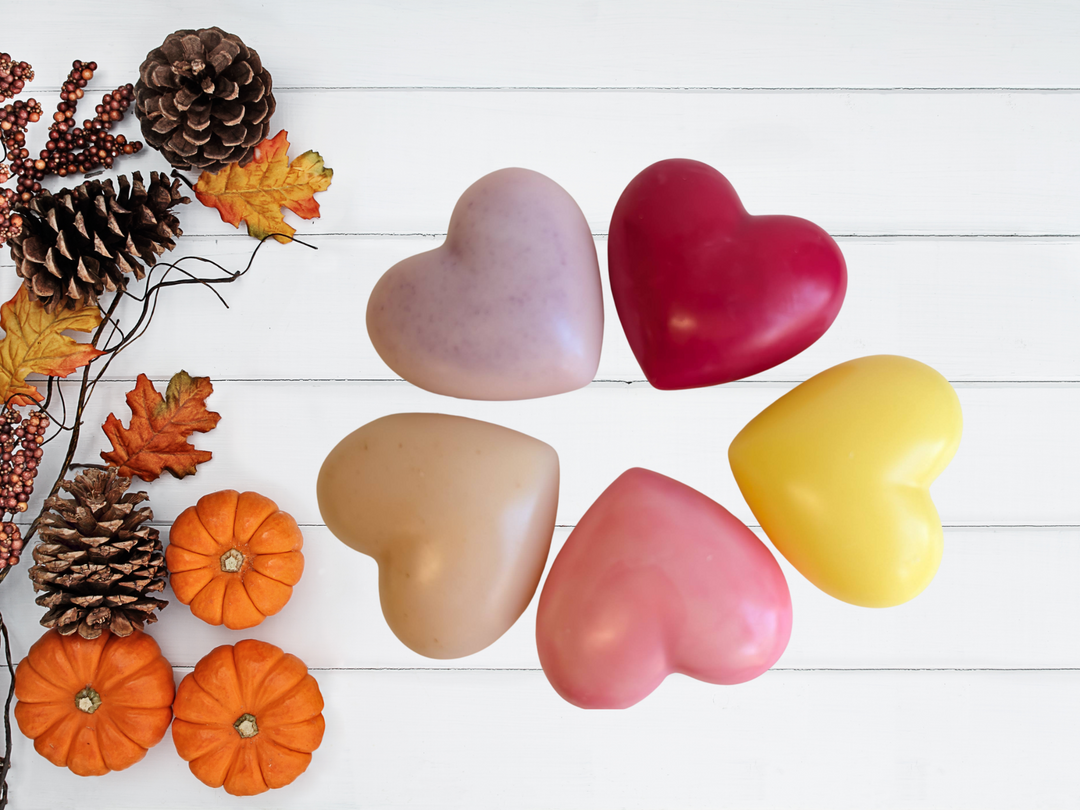 Set of five heart-shaped wax sachets in assorted colors on a white surface