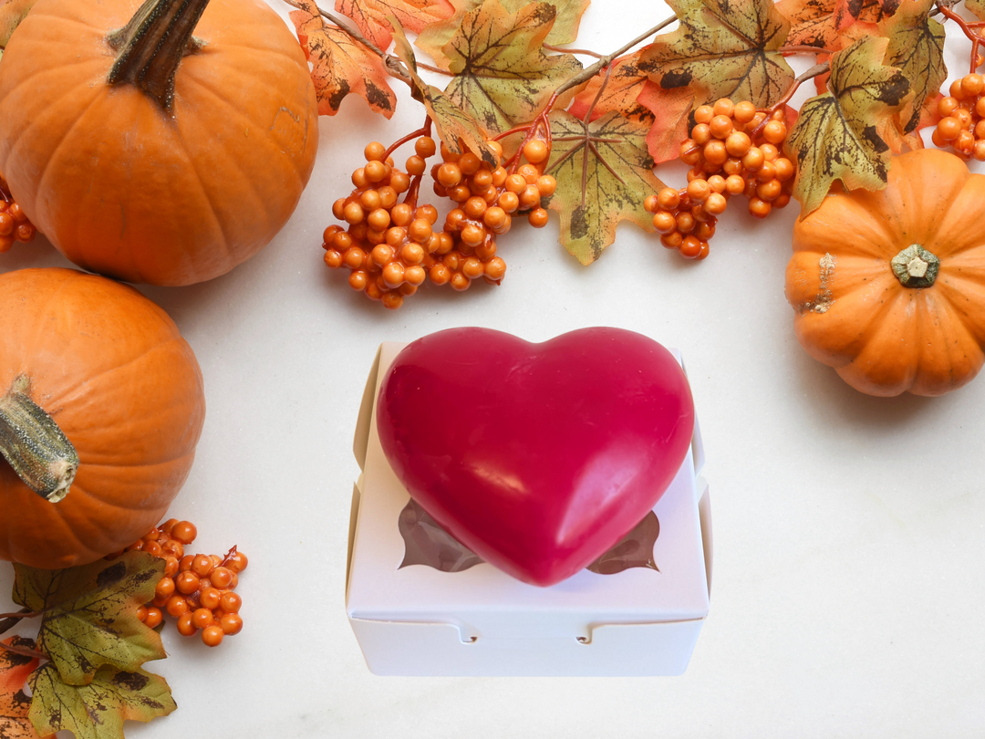 Red heart-shaped wax sachet in a white box with pumpkins and autumn berries