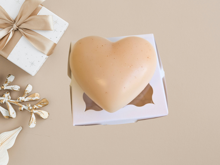 Cream heart wax freshener in white gift box, shown on a tray