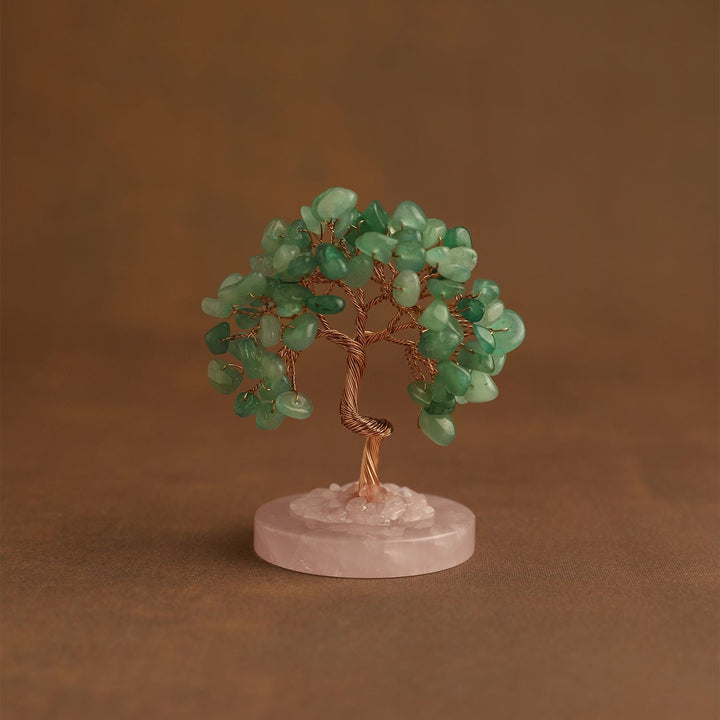Mini crystal tree with green gemstone leaves on pink stone base