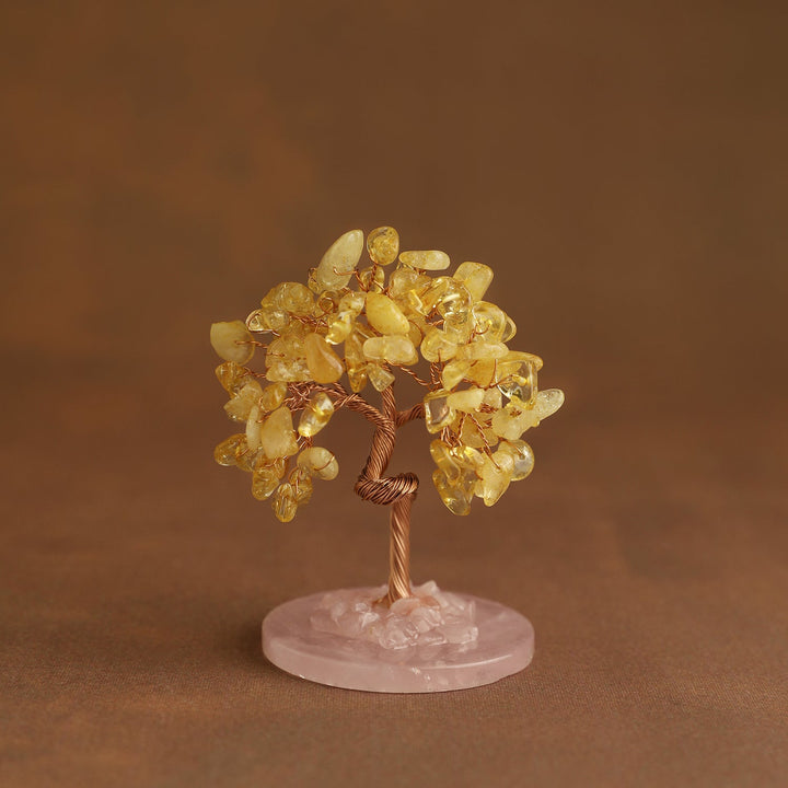 Crystal tree ornament with golden yellow gemstone chips on pink round base