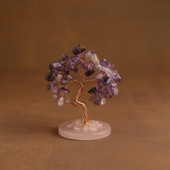 Crystal tree ornament with purple and clear gemstone chips on pink base