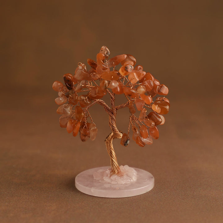 Mini crystal tree with orange gemstone chips on pink stone base