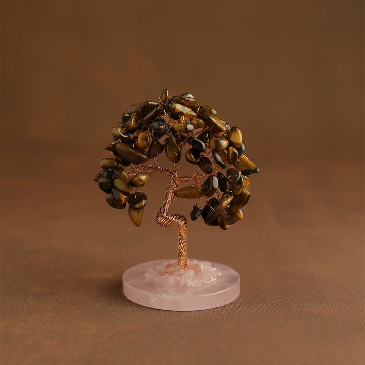 Crystal tree ornament with dark golden-brown gemstone chips on pink round base