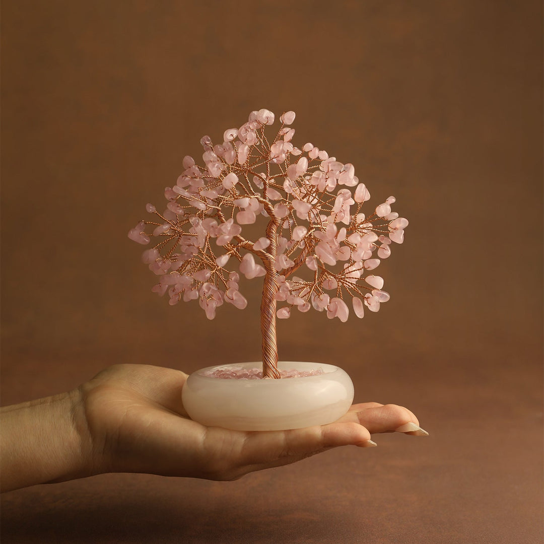 Pink strawberry quartz crystal tree with gold-toned wire trunk and round white base