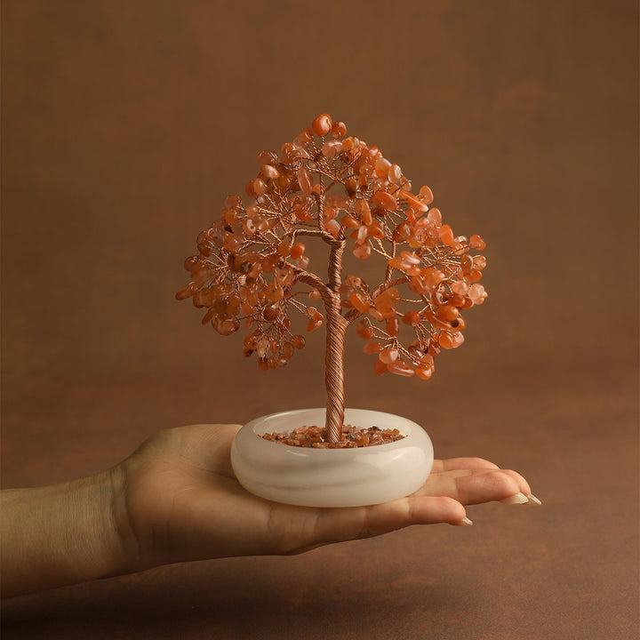 Orange carnelian crystal tree with gold-toned wire trunk and round white base