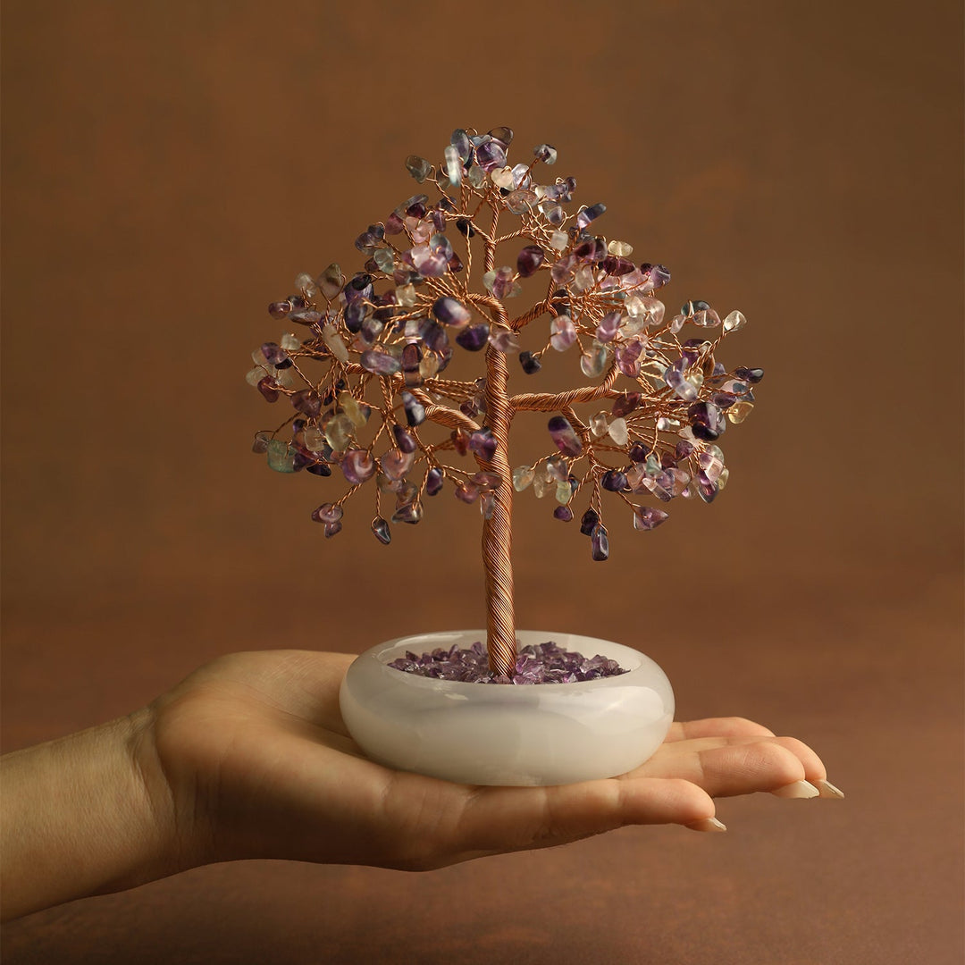 Purple crystal gemstone tree with twisted brown trunk on white jade-style base