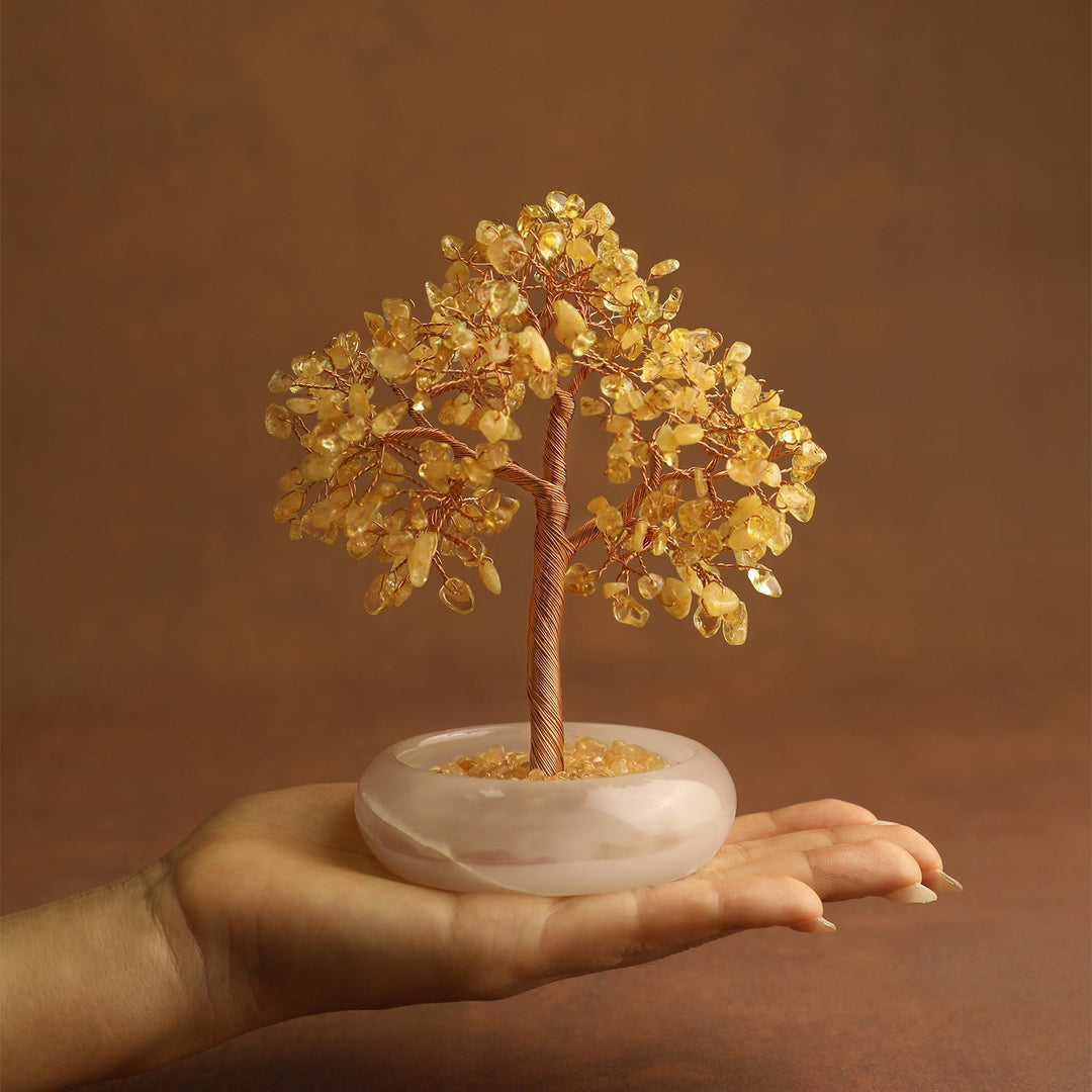 Golden crystal gemstone tree on white round jade-style base