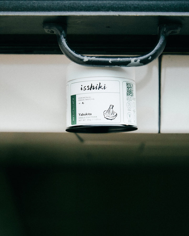 Small ceremonial matcha tin on a shelf ledge, label facing forward
