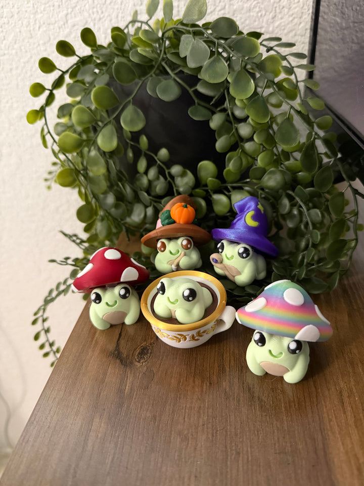 Frog toy with mushroom hat, holding clicker, green face and painted details