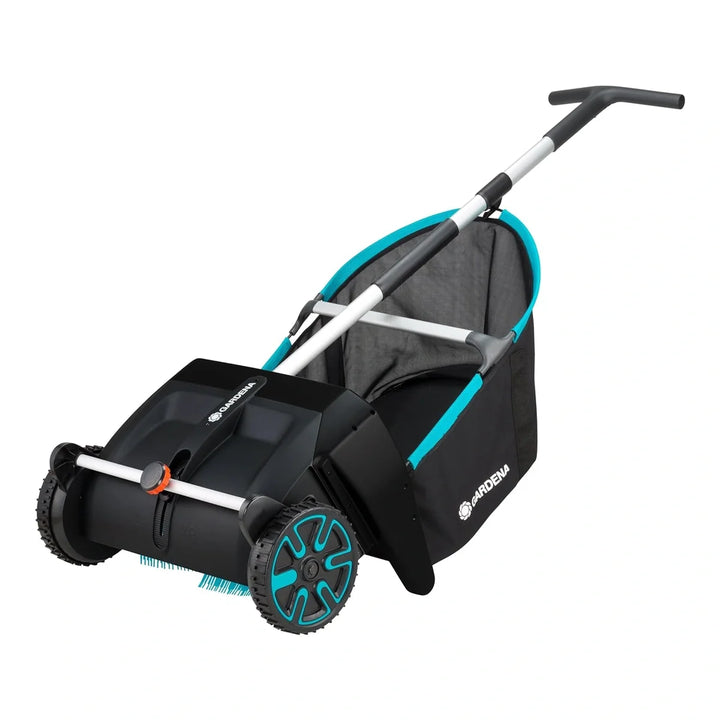 Leaf and lawn collector with black hopper, teal trim, and push handle