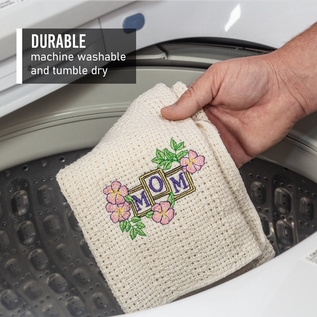 Off-white cotton kitchen towel with colorful floral “HOME” embroidery