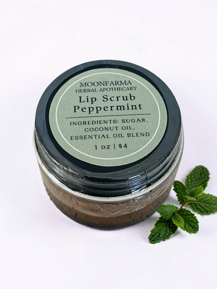 Lip scrub jar labeled Peppermint with dark brown gritty scrub and clear lid