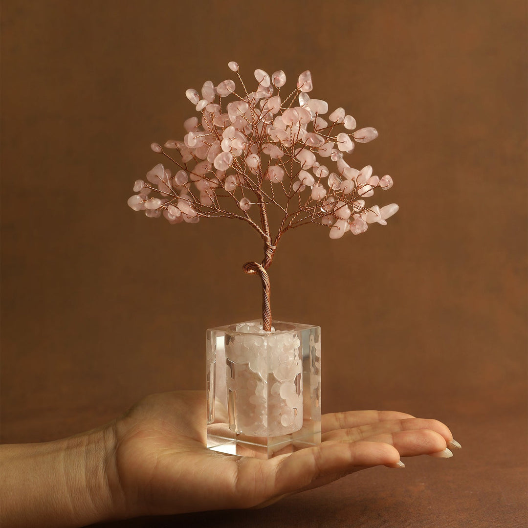 Pink crystal tree ornament with wire branches and rose quartz-style chips in a clear cube base