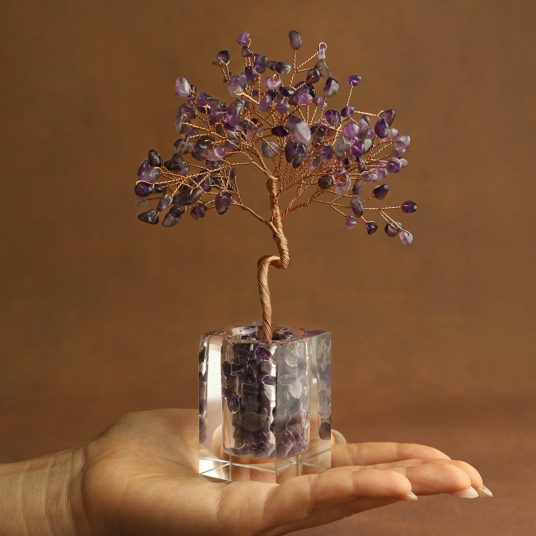 Purple crystal tree ornament with wire branches and amethyst-style stones in a clear cube base