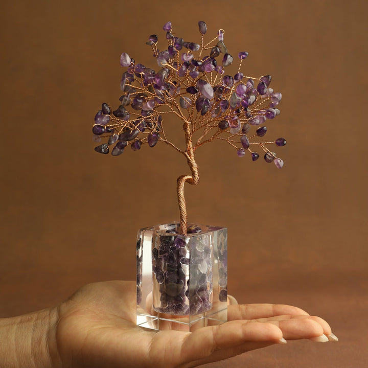 Purple crystal tree ornament with wire branches and amethyst-style stones in a clear cube base
