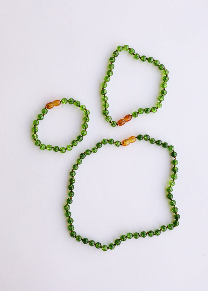 Peridot green gemstone beaded necklace with small amber/golden accent beads