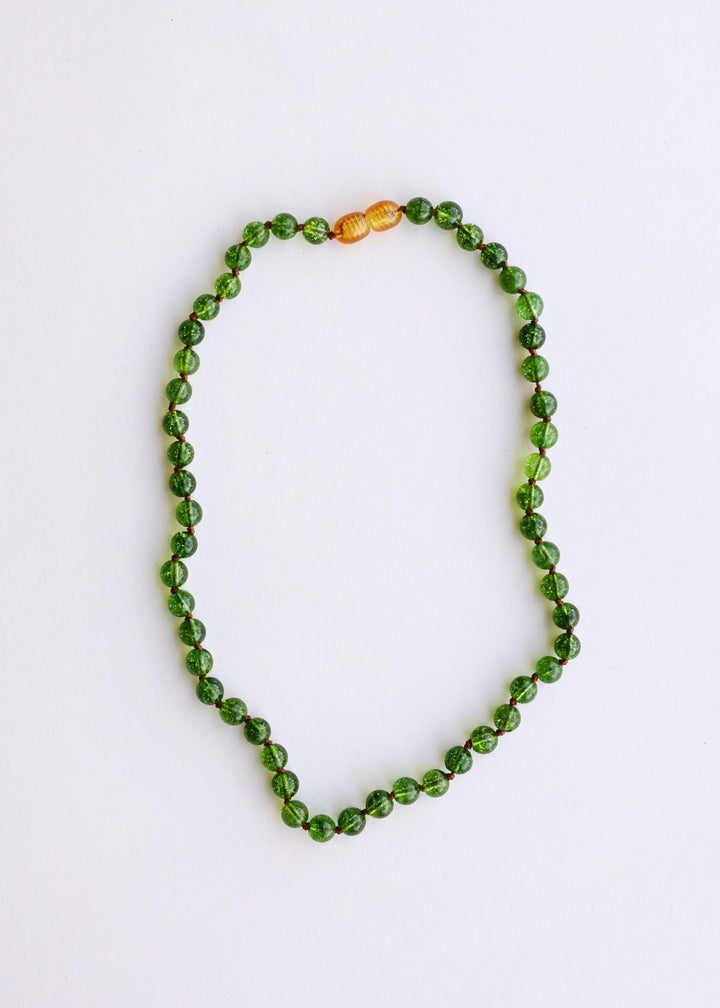 Peridot green gemstone beaded necklace with two amber/golden accent beads on top