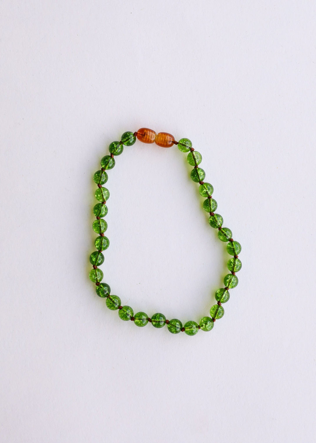 Peridot green gemstone beaded necklace with one amber/golden accent bead at top