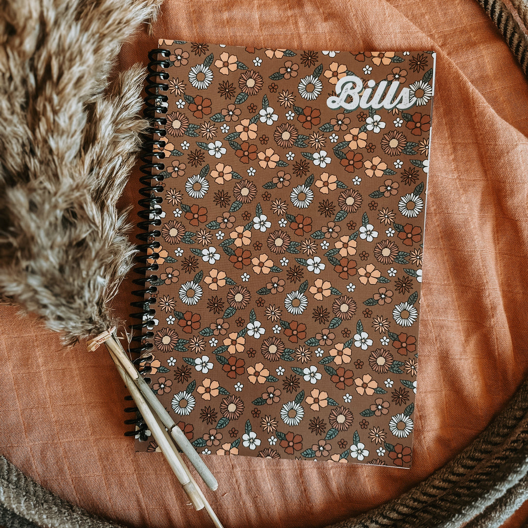 Brown floral bill tracker notebook with spiral binding and “Bill” title on cover
