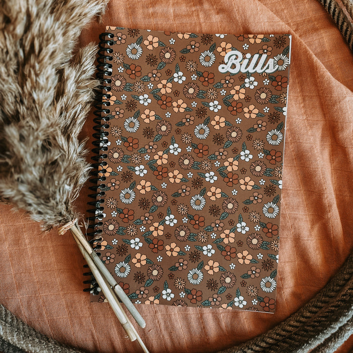 Brown floral bill tracker notebook with spiral binding and “Bill” title on cover