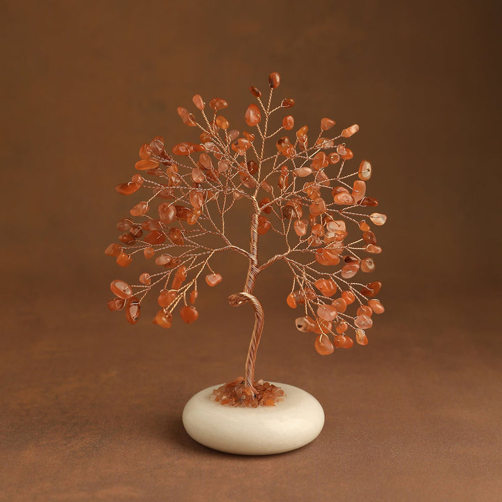 Orange crystal tree with gem leaves and a white jade stone base