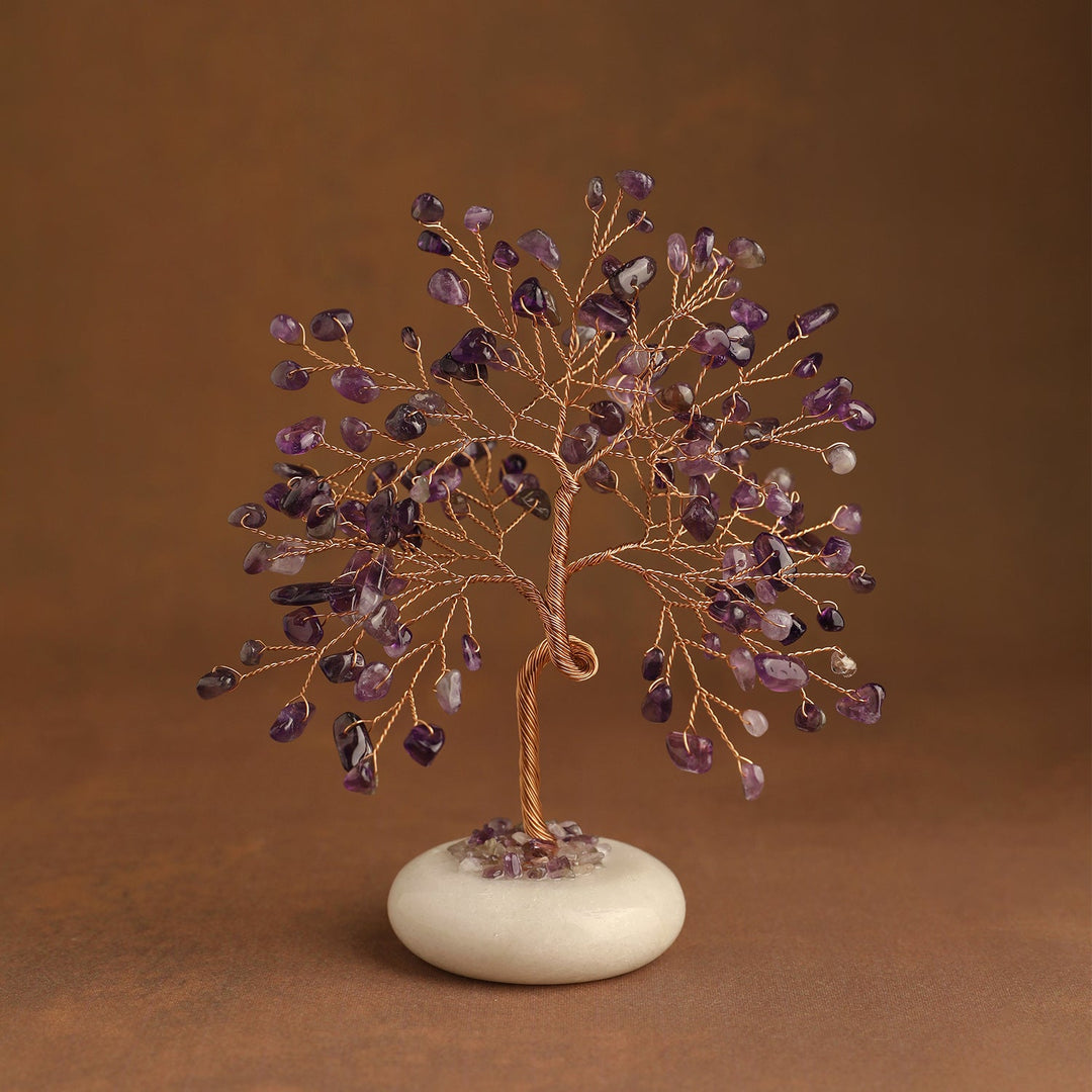 Purple crystal tree with gemstone leaves and white jade stone base