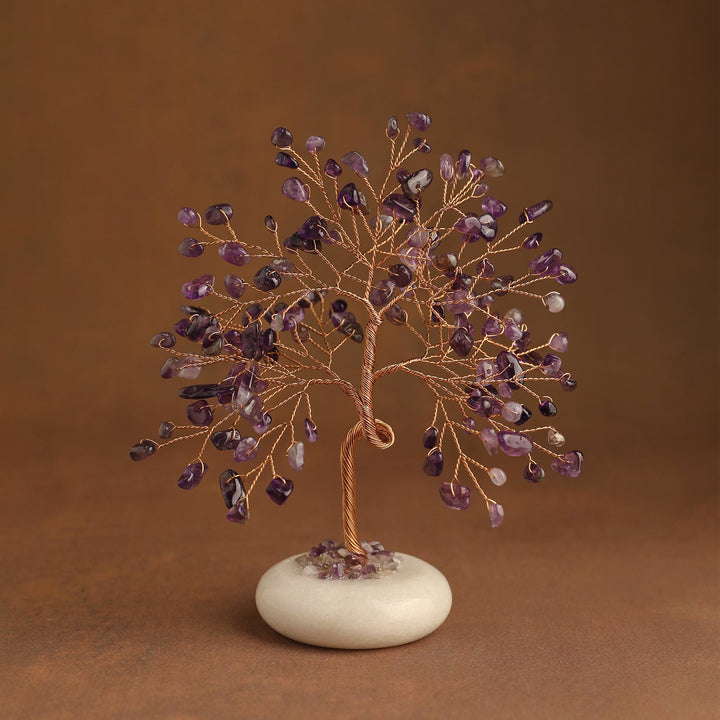 Purple crystal tree with gemstone leaves and white jade stone base