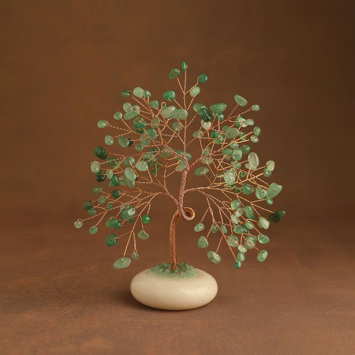 Green crystal tree with gem leaves and a white jade stone base