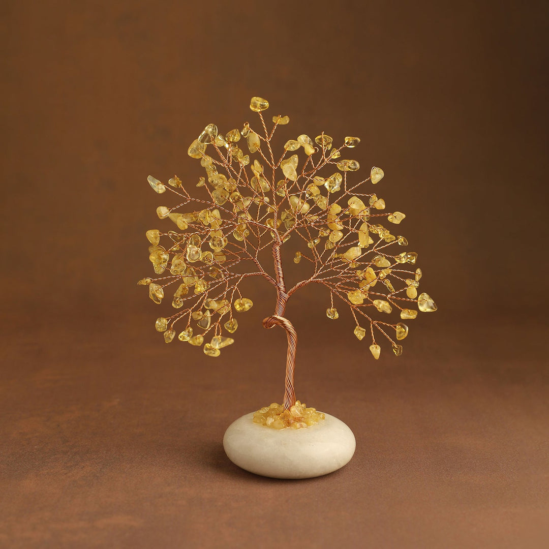 Golden yellow crystal tree with gem leaves and a white jade stone base