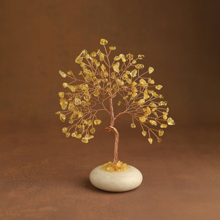 Golden yellow crystal tree with gem leaves and a white jade stone base