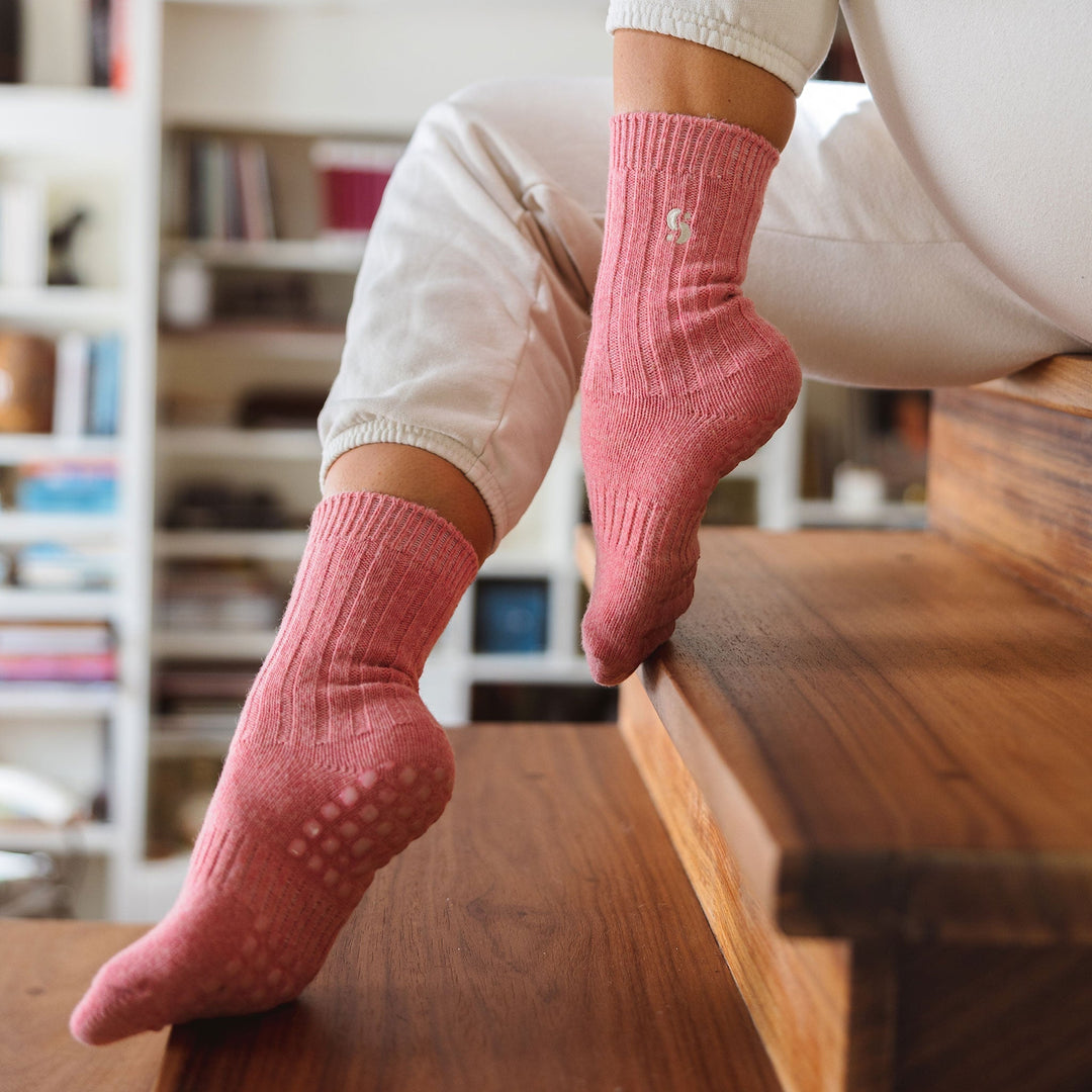 Coral non-slip socks on a person standing, showing full length and grip sole