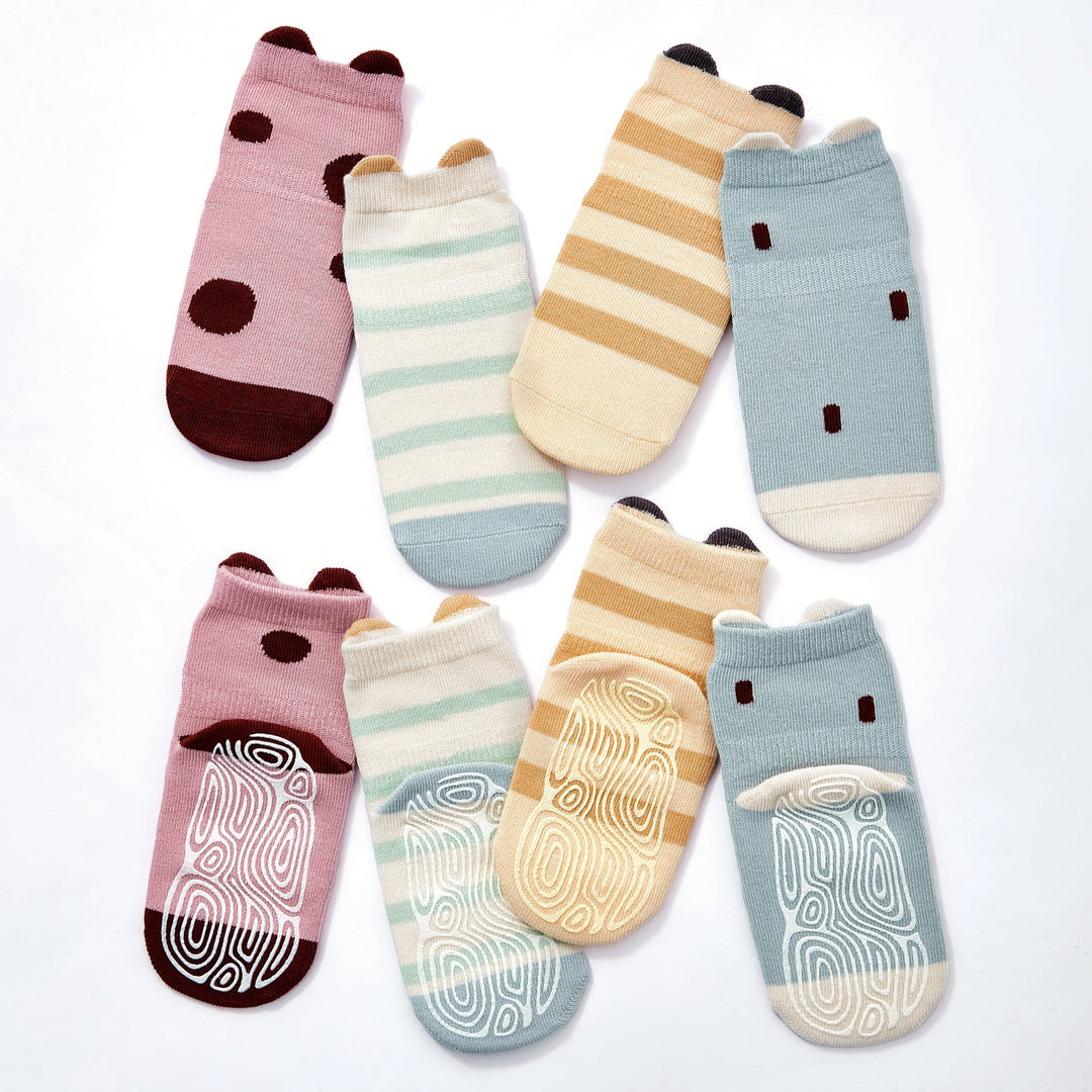 Baby non-slip socks set with pink and blue dots, beige stripes, and ladybug-graphic grips