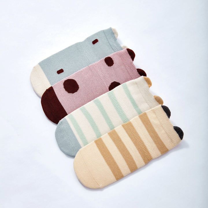 Baby non-slip socks set layered together: blue stripe, pink dot, beige stripe, and gray dot
