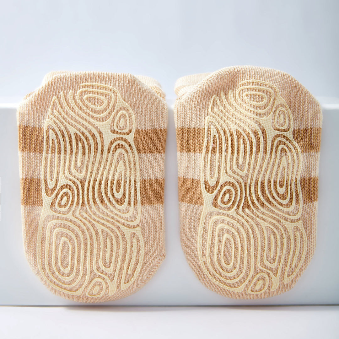 Baby non-slip socks with close-up beige stripes and ladybug-graphic grippers