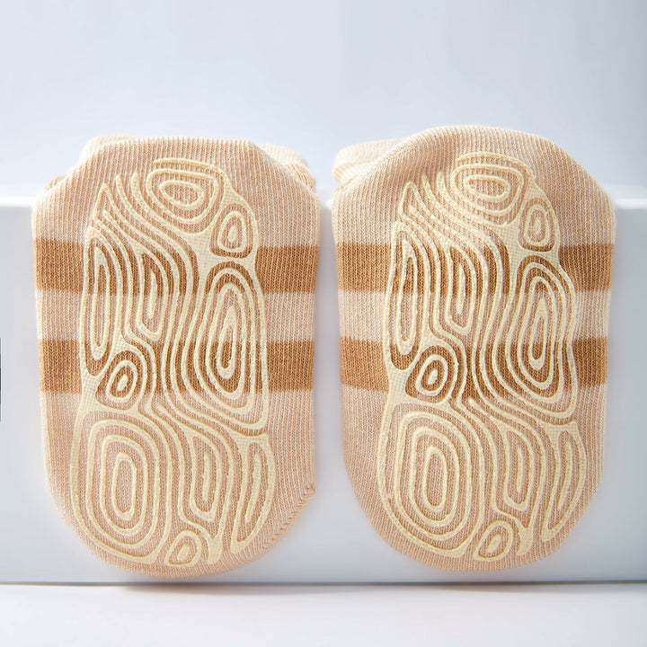 Baby non-slip socks with close-up beige stripes and ladybug-graphic grippers