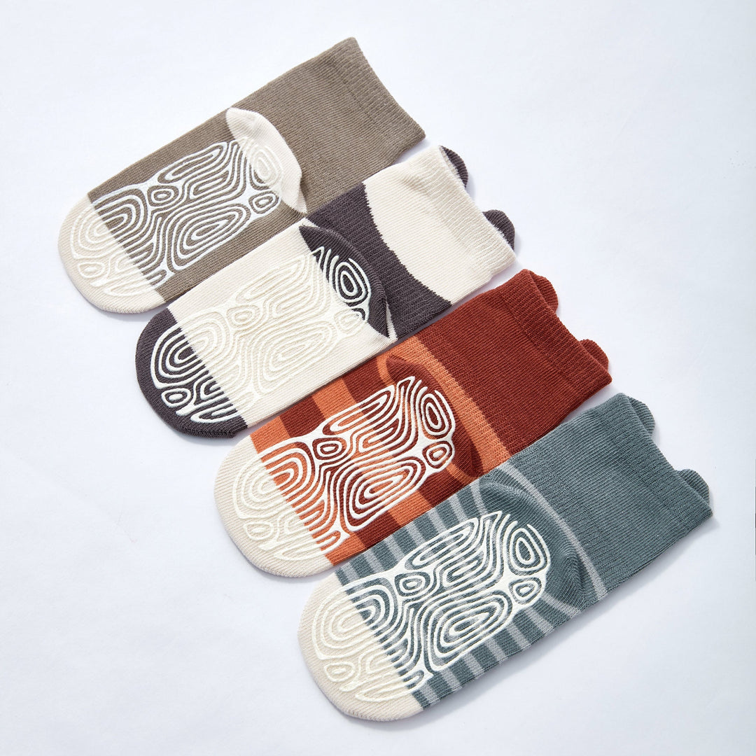Four pairs of non-slip crew socks with bear and swirl prints in rust, orange, blue-gray, taupe