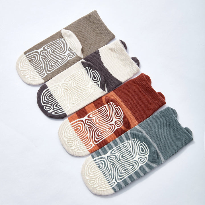 Four pairs of non-slip crew socks with bear and swirl prints in rust, orange, blue-gray, taupe