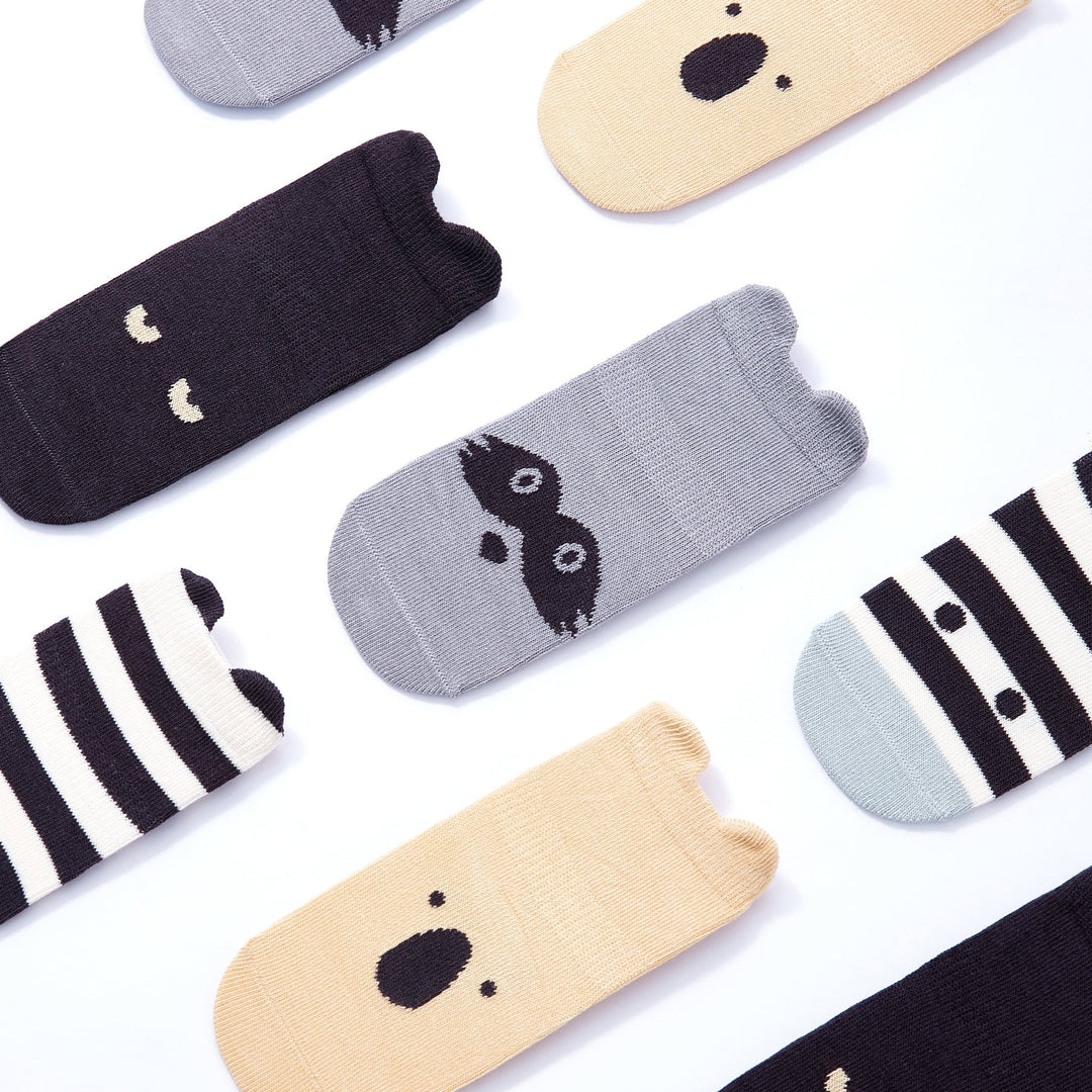 Assorted baby non-slip socks with polar bear-style faces, stripes, and grippy soles