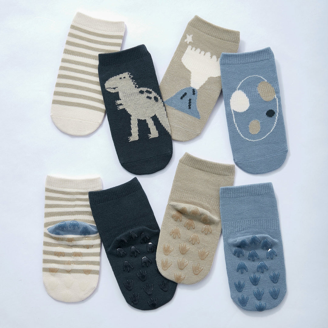 4-pack baby dinosaur socks in navy, blue, beige, and striped designs