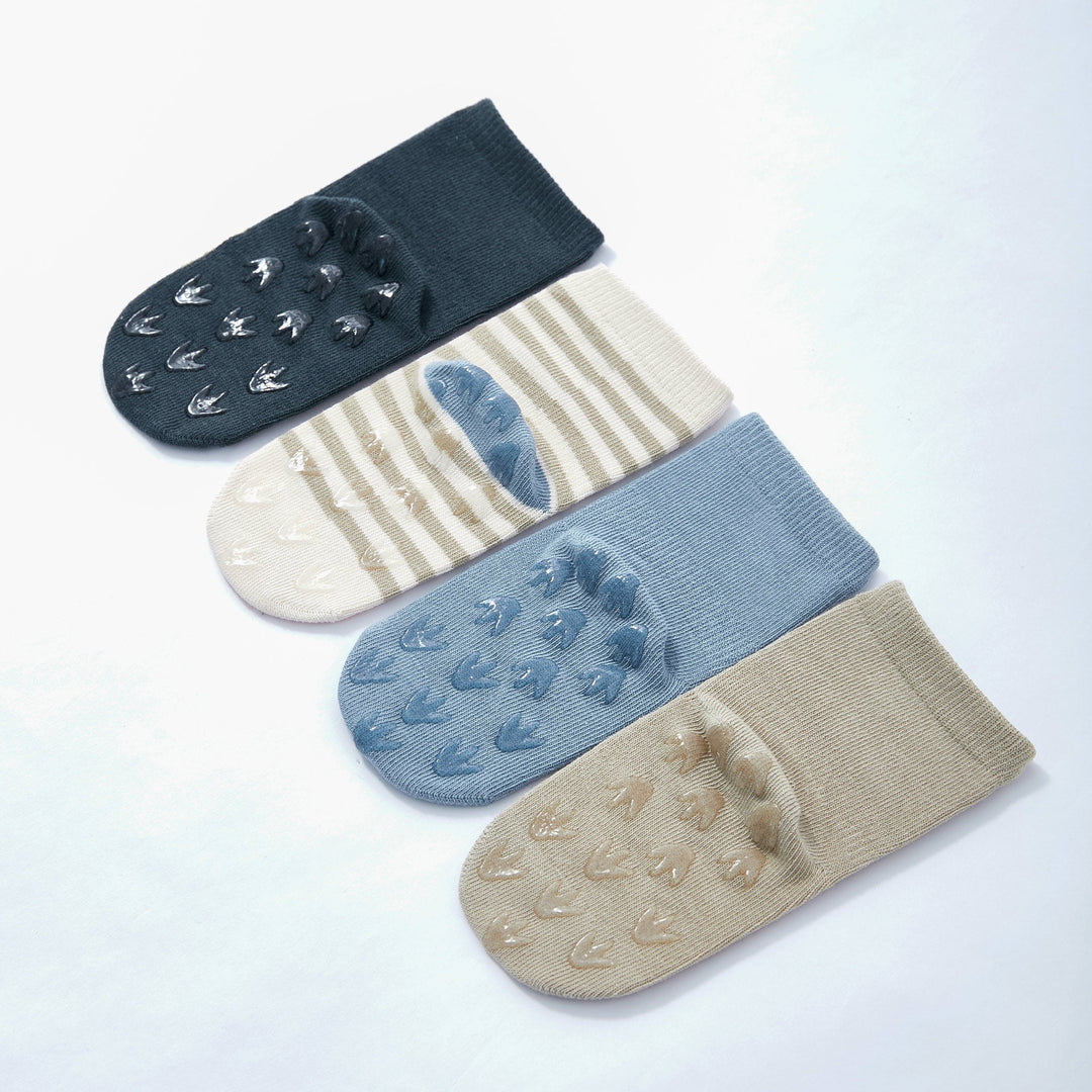 Baby dinosaur crew socks set with paw-print grip soles in navy, blue, and tan