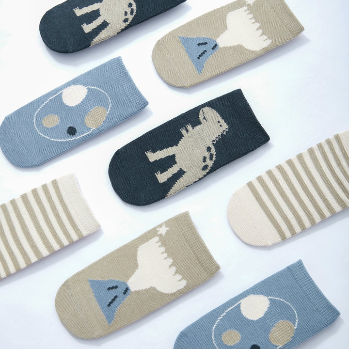 Assorted baby dinosaur socks: blue, beige, and navy with animal silhouette prints
